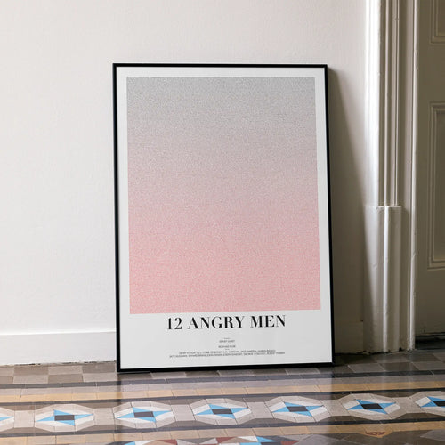 A framed 12 Angry Men movie script poster leaning against a wall in a minimalist interior.