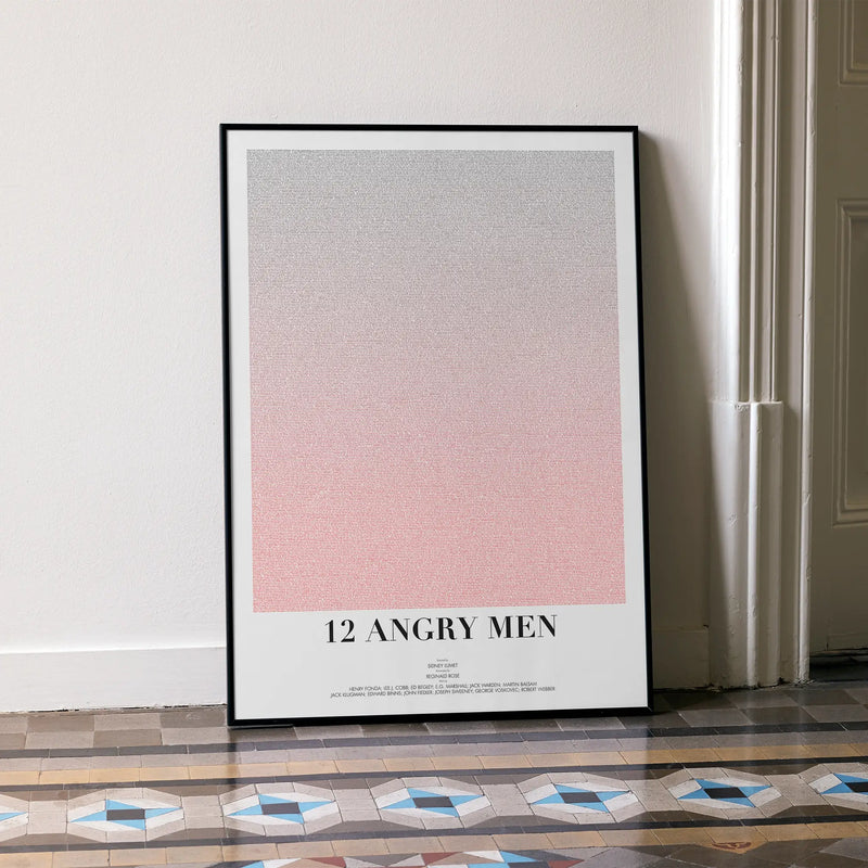 A framed 12 Angry Men movie script poster leaning against a wall in a minimalist interior.