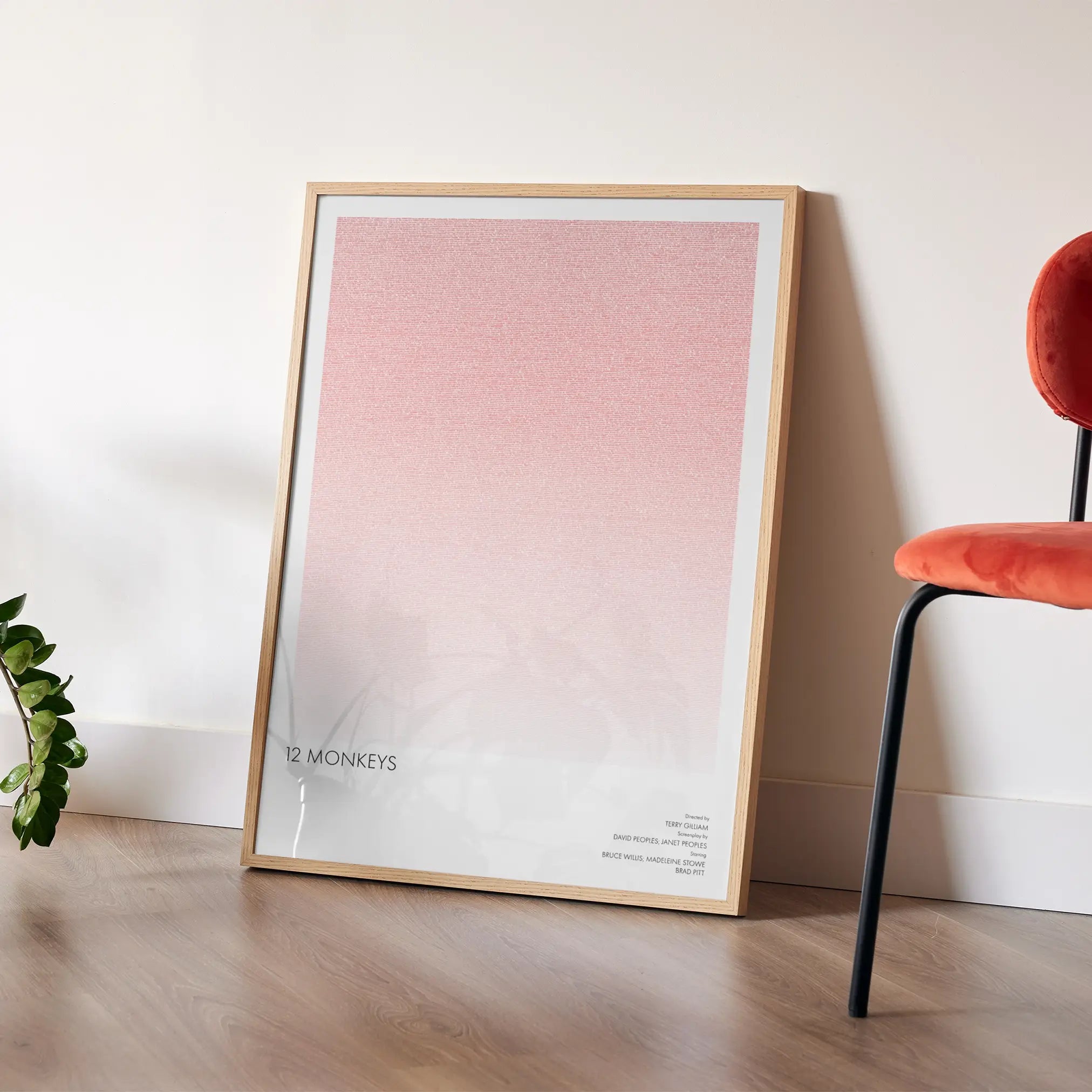 A framed 12 Monkeys movie script poster placed in a bright interior environment.