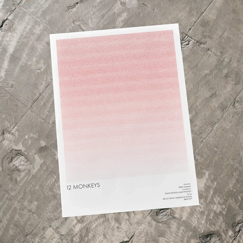 A 12 Monkeys movie script poster laid flat on a textured floor surface.