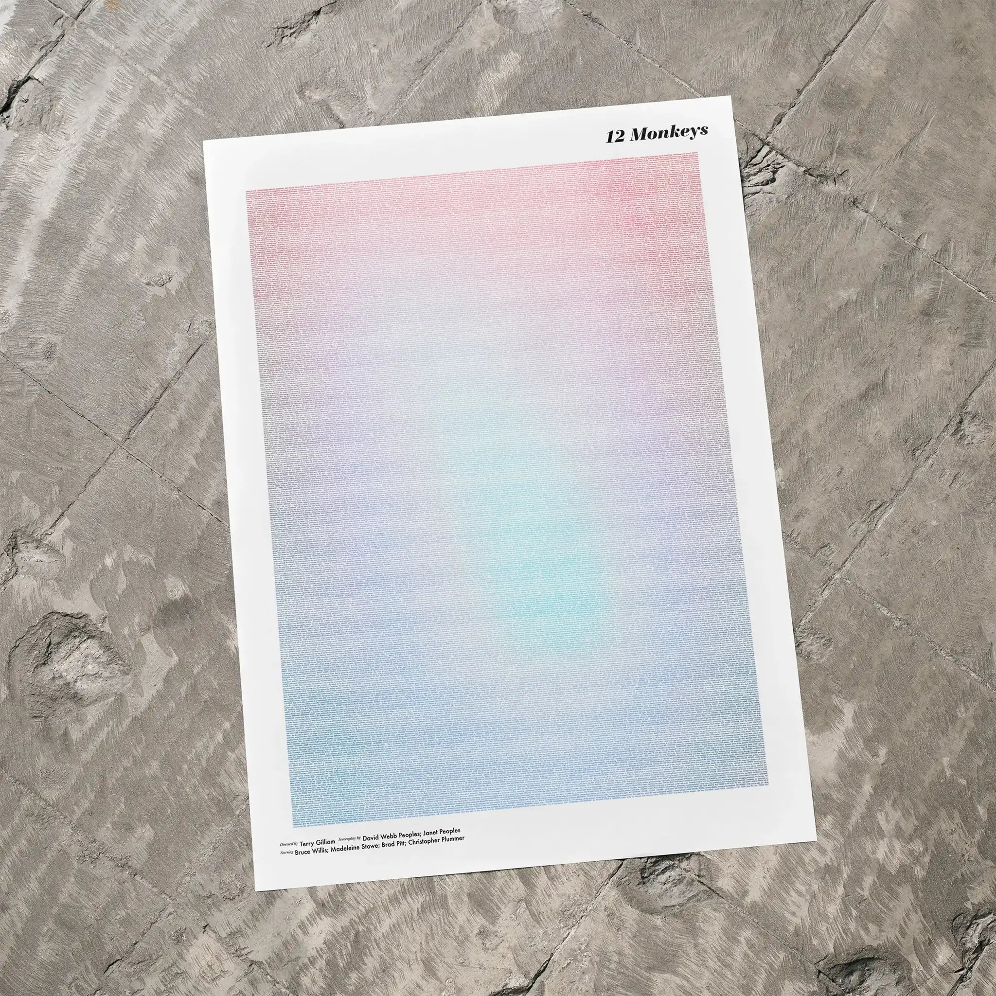 A 12 Monkeys movie script poster laid flat on a textured floor surface.