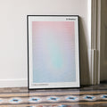 A framed 12 Monkeys movie script poster leaning against a wall in a minimalist interior.