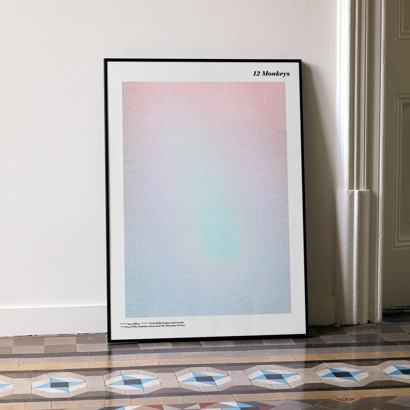 A framed 12 Monkeys movie script poster leaning against a wall in a minimalist interior.