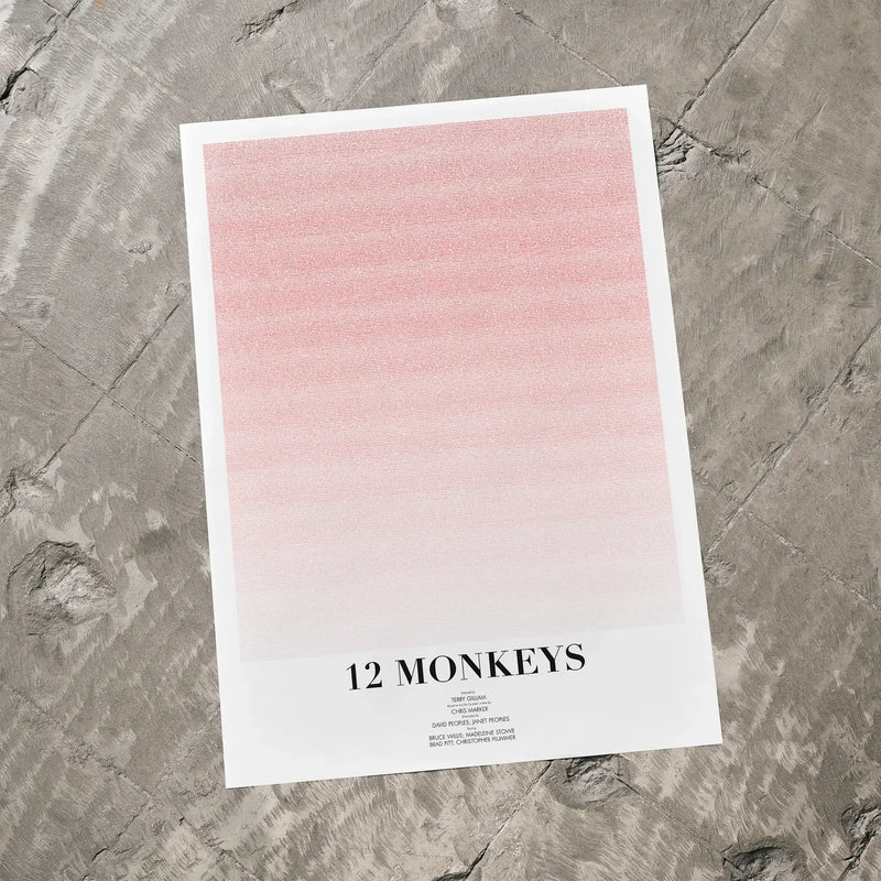 A 12 Monkeys movie script poster laid flat on a textured floor surface.