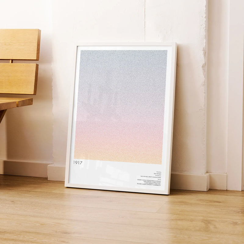 A framed 1917 movie script poster leaning against a wall in a modern interior.