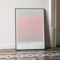 A framed 2001: A Space Odyssey movie script poster leaning against a wall in a minimalist interior.