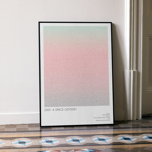A framed 2001: A Space Odyssey movie script poster leaning against a wall in a minimalist interior.