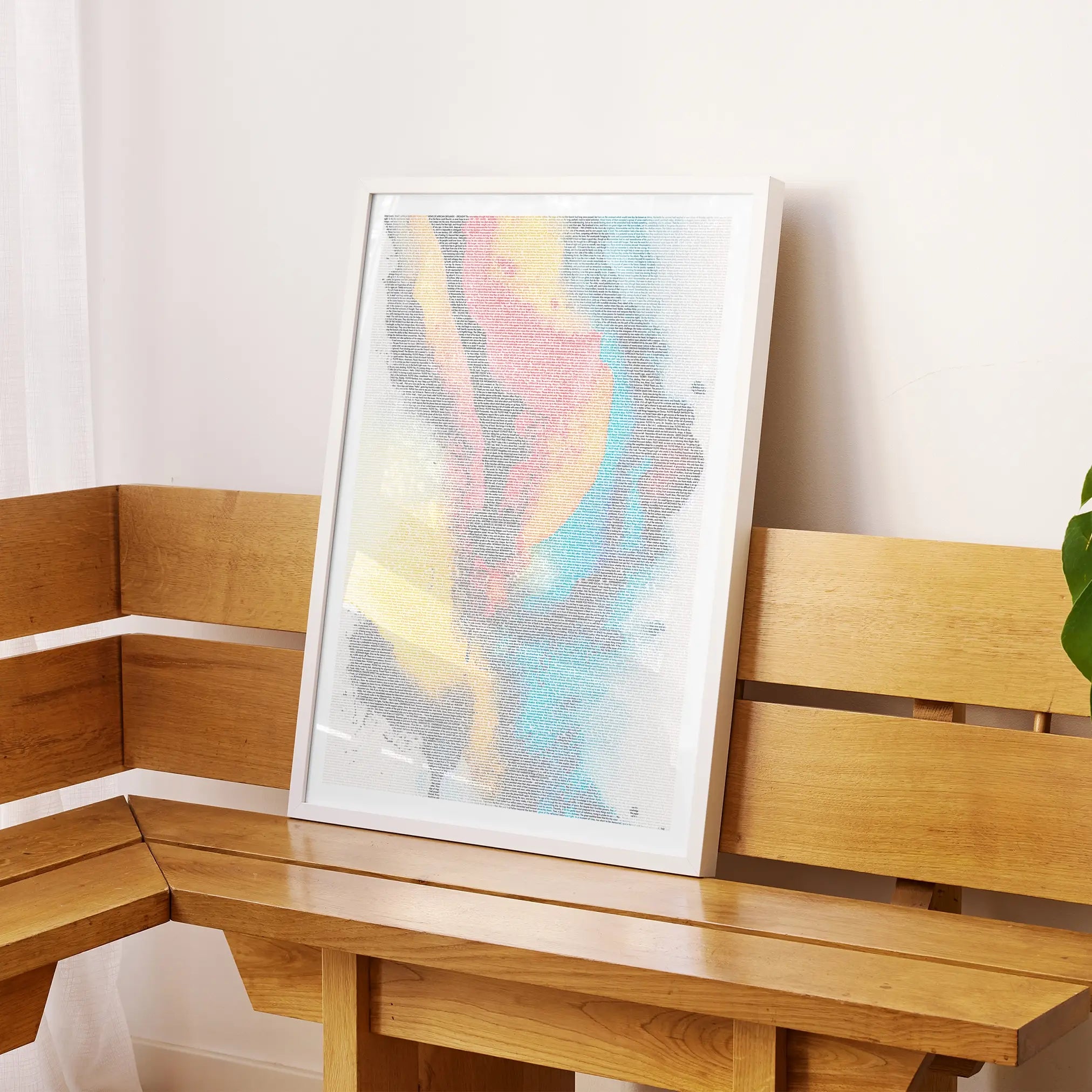 A framed 2001: A Space Odyssey movie script poster displayed on a sideboard in a contemporary space.