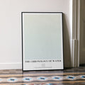 Framed poster titled 'The Chronology of Water' on a wall.