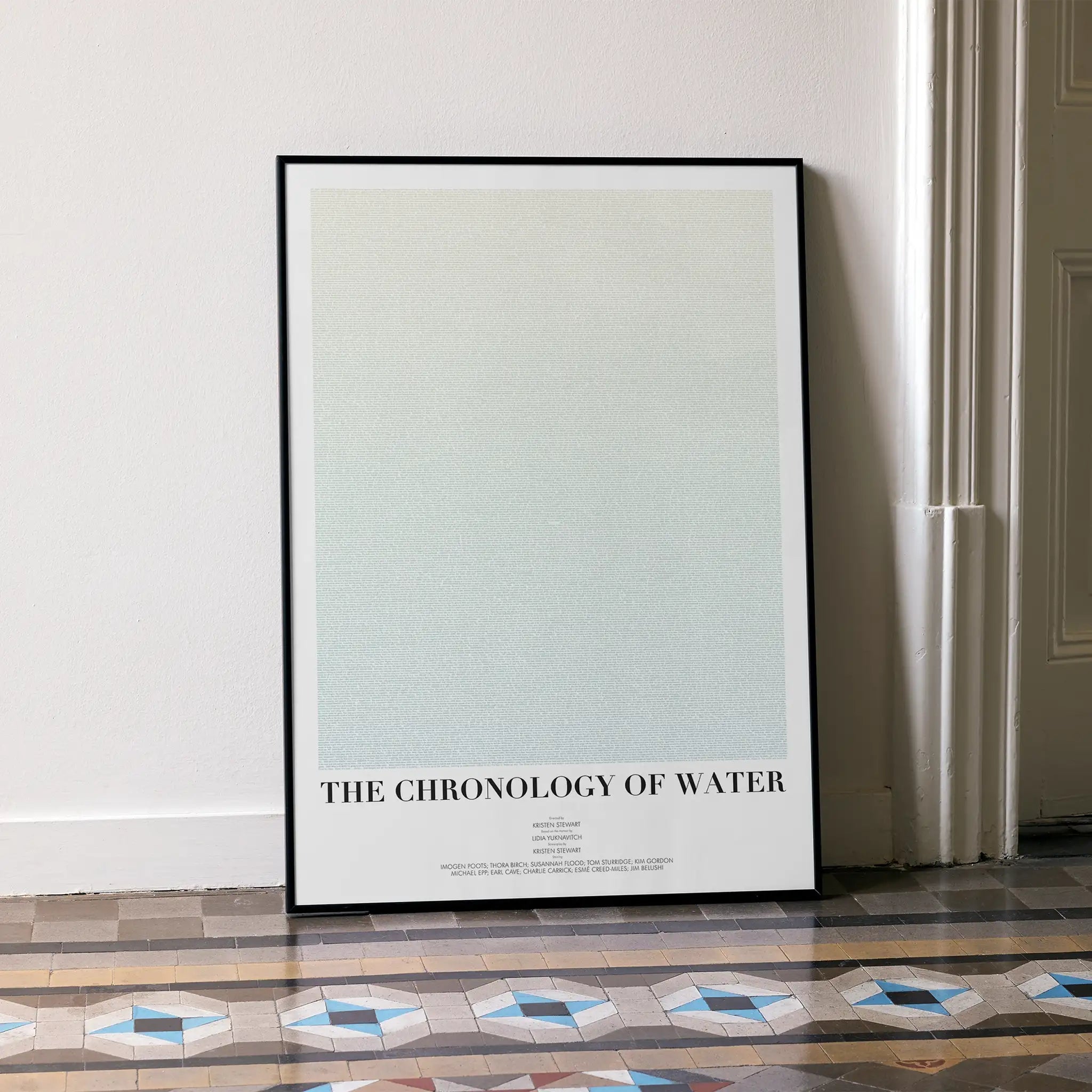 Framed poster titled 'The Chronology of Water' on a wall.