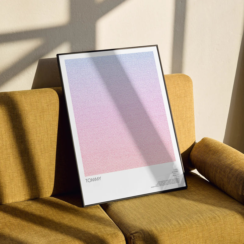 A framed Tommy movie script poster styled in a clean interior setting.