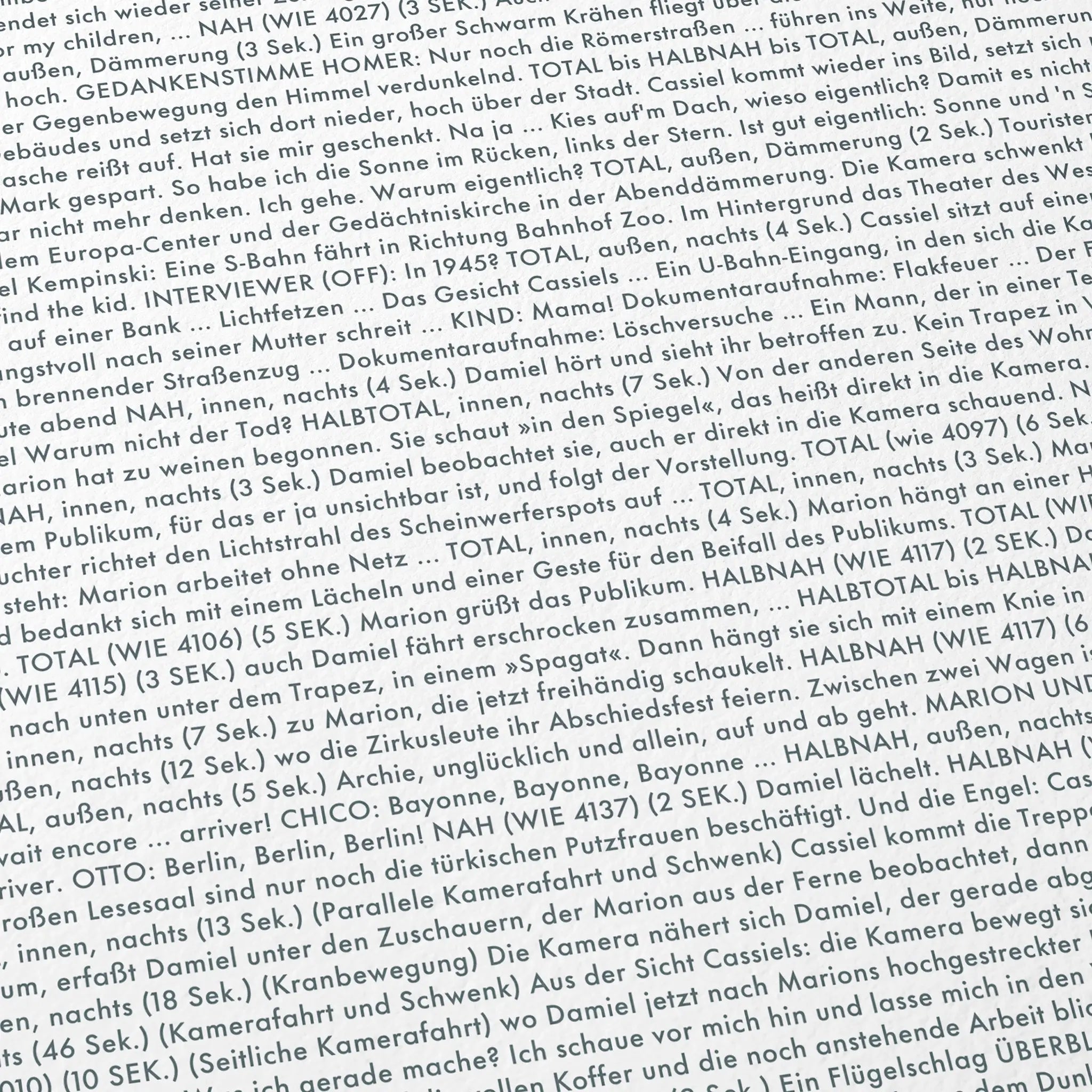 Close-up detail of the Wings of Desire movie script poster showing dense typographic text.