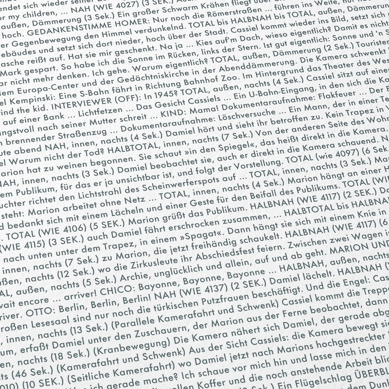 Close-up detail of the Wings of Desire movie script poster showing dense typographic text.