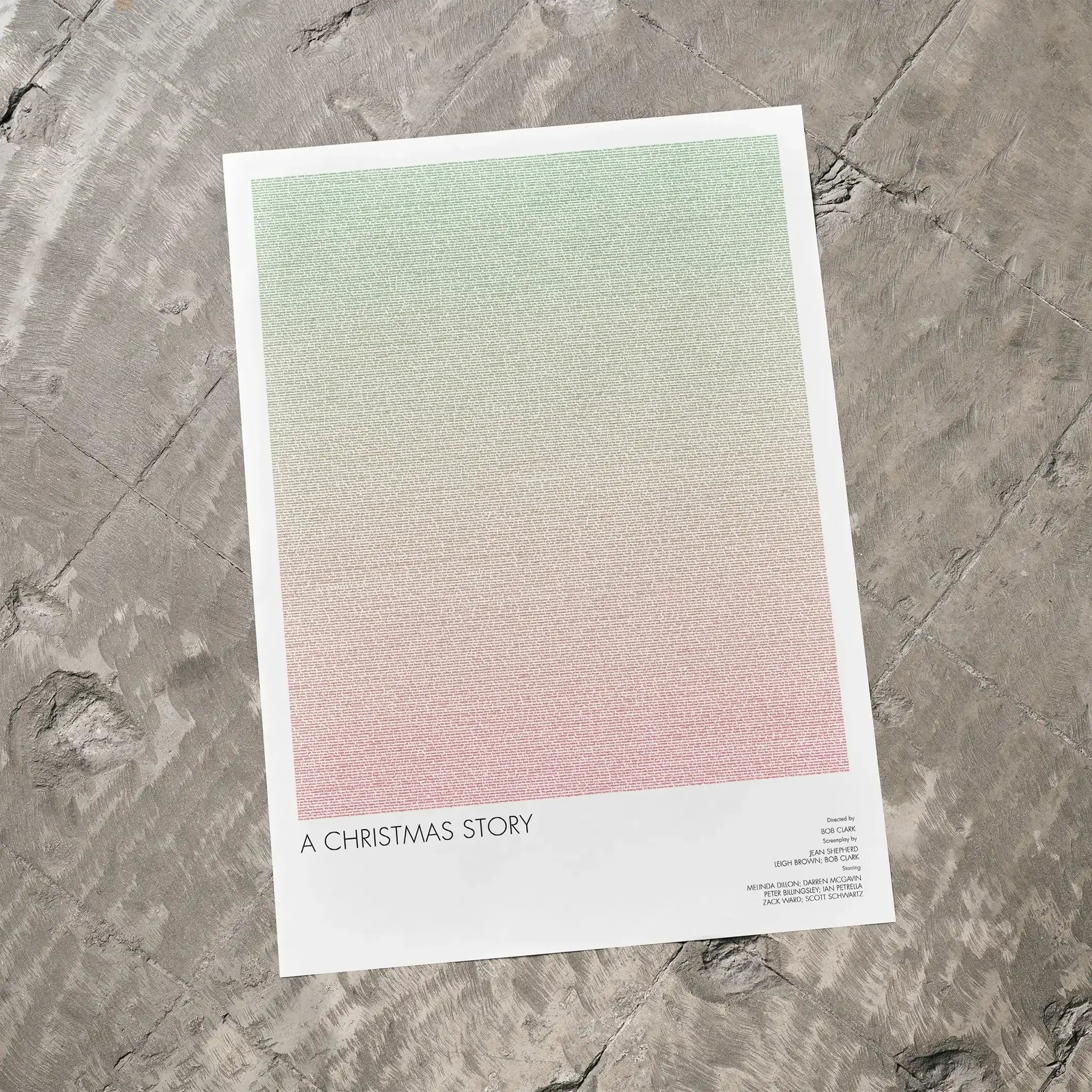 A A Christmas Story movie script poster laid flat on a textured floor surface.