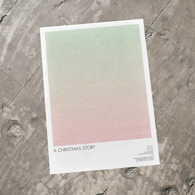 A A Christmas Story movie script poster laid flat on a textured floor surface.