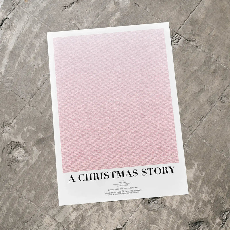 A A Christmas Story movie script poster laid flat on a textured floor surface.