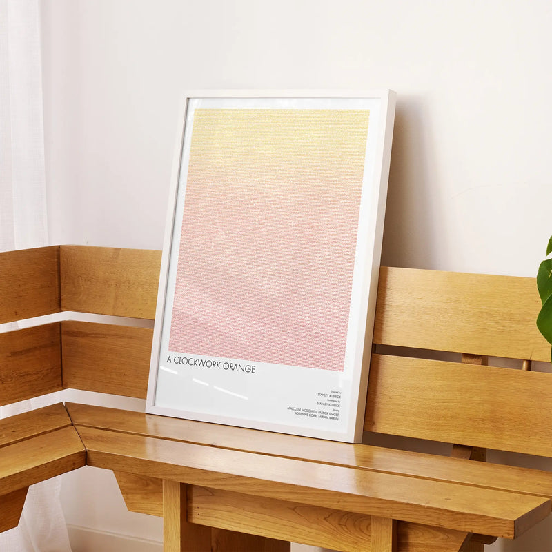A framed A Clockwork Orange movie script poster displayed on a sideboard in a contemporary space.