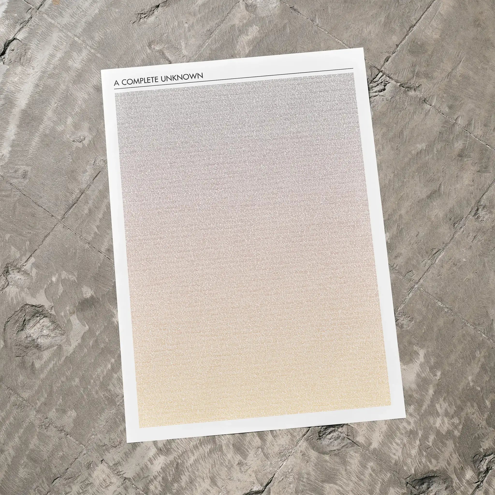 A A Complete Unknown movie script poster laid flat on a textured floor surface.