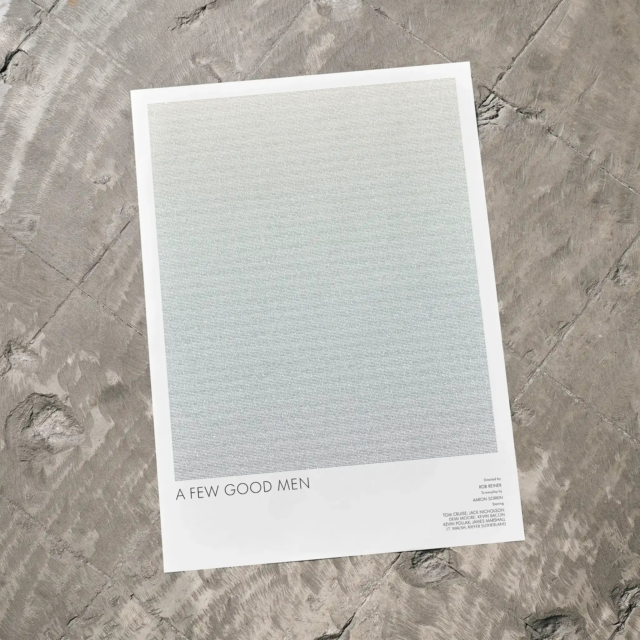 A A Few Good Men movie script poster laid flat on a textured floor surface.