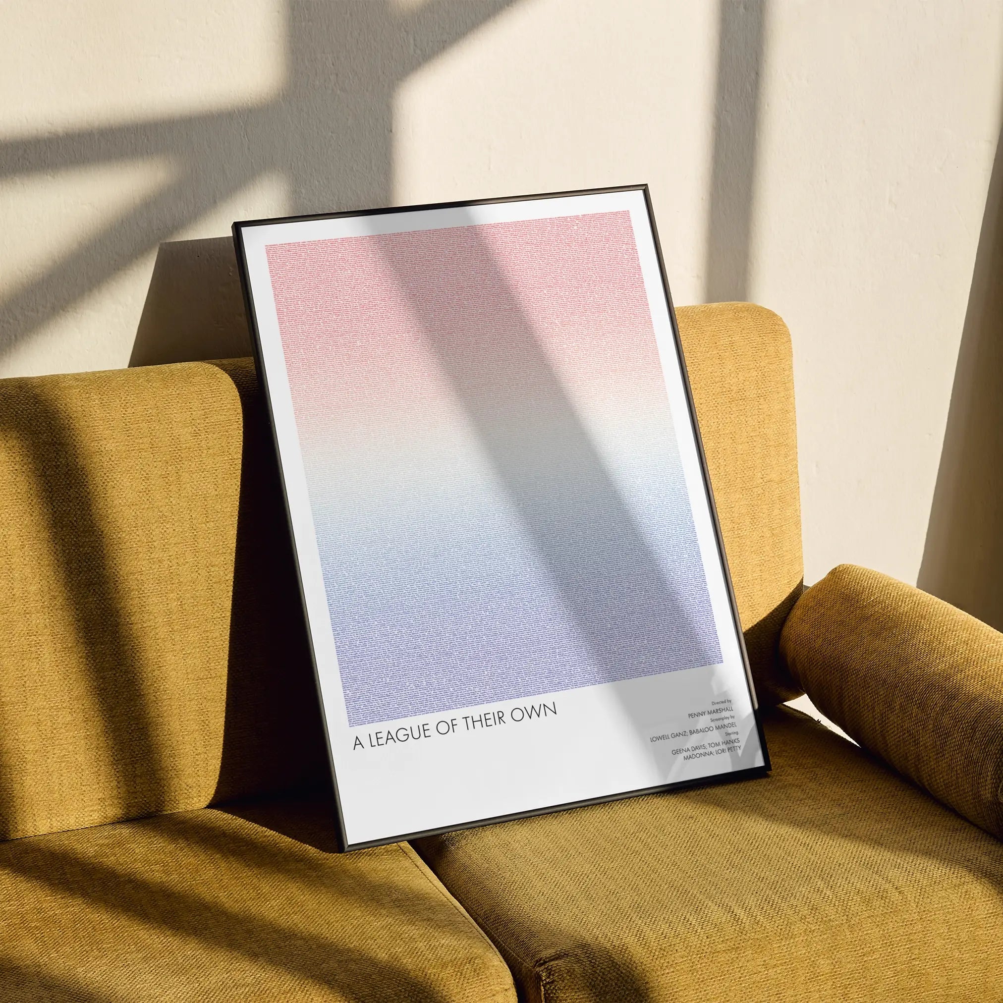 A framed A League of Their Own movie script poster styled in a clean interior setting.