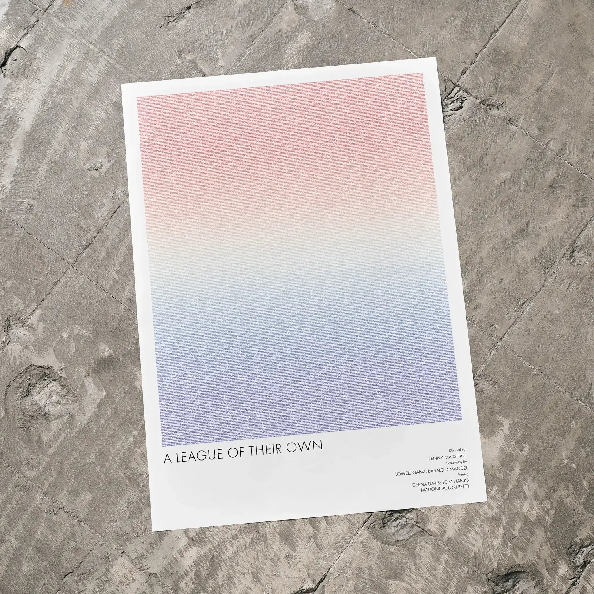 A A League of Their Own movie script poster laid flat on a textured floor surface.