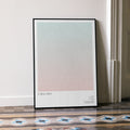 A framed A Real Pain movie script poster leaning against a wall in a minimalist interior.