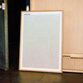 A framed A Real Pain movie script poster displayed in a contemporary interior setting.