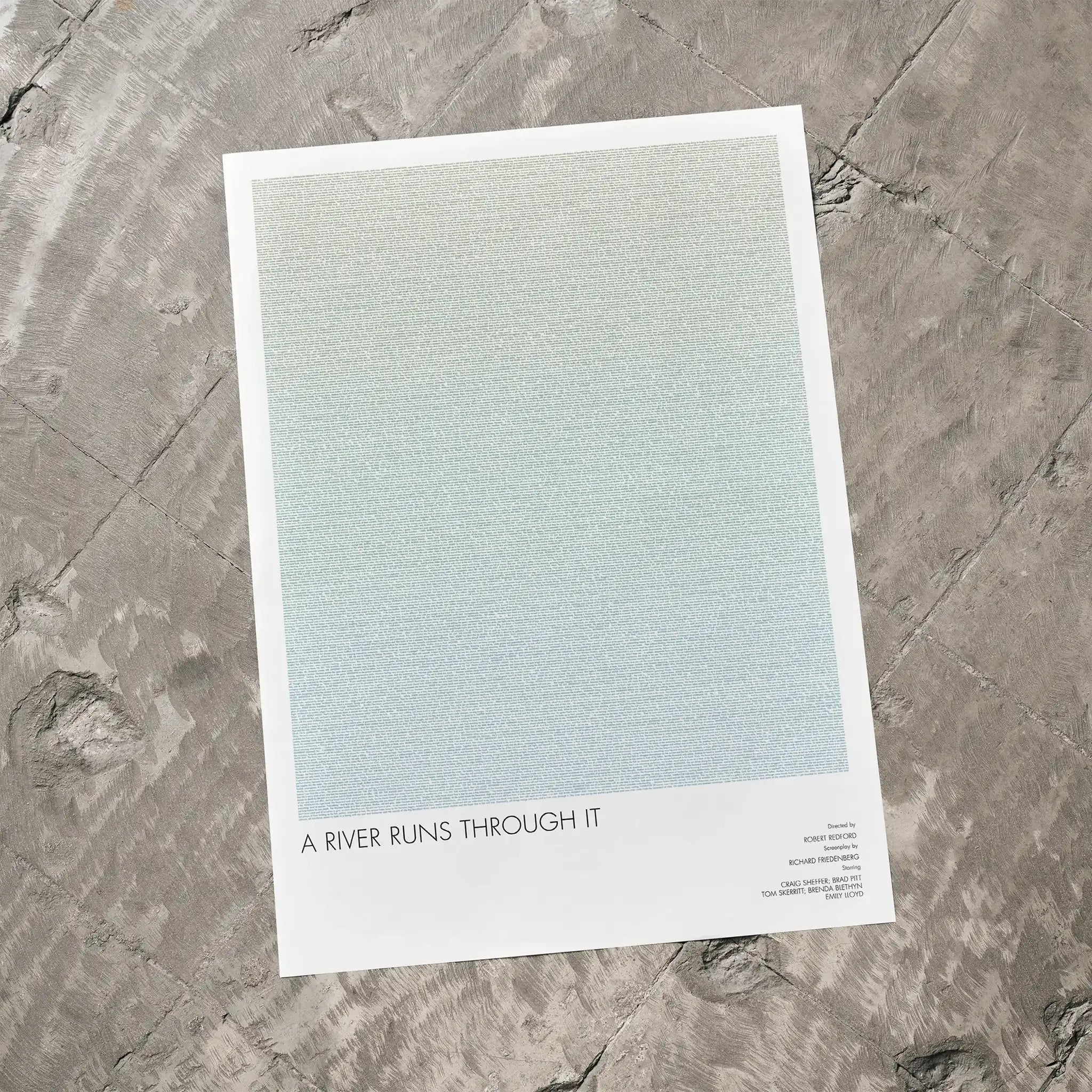 A A River Runs Through It movie script poster laid flat on a textured floor surface.