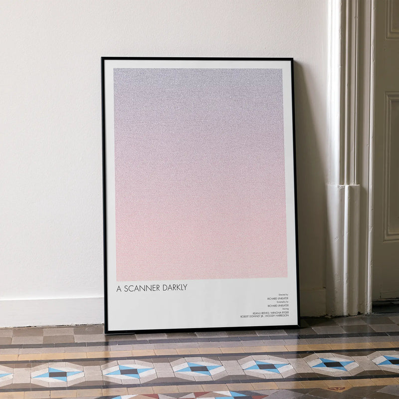 A framed A Scanner Darkly movie script poster leaning against a wall in a minimalist interior.