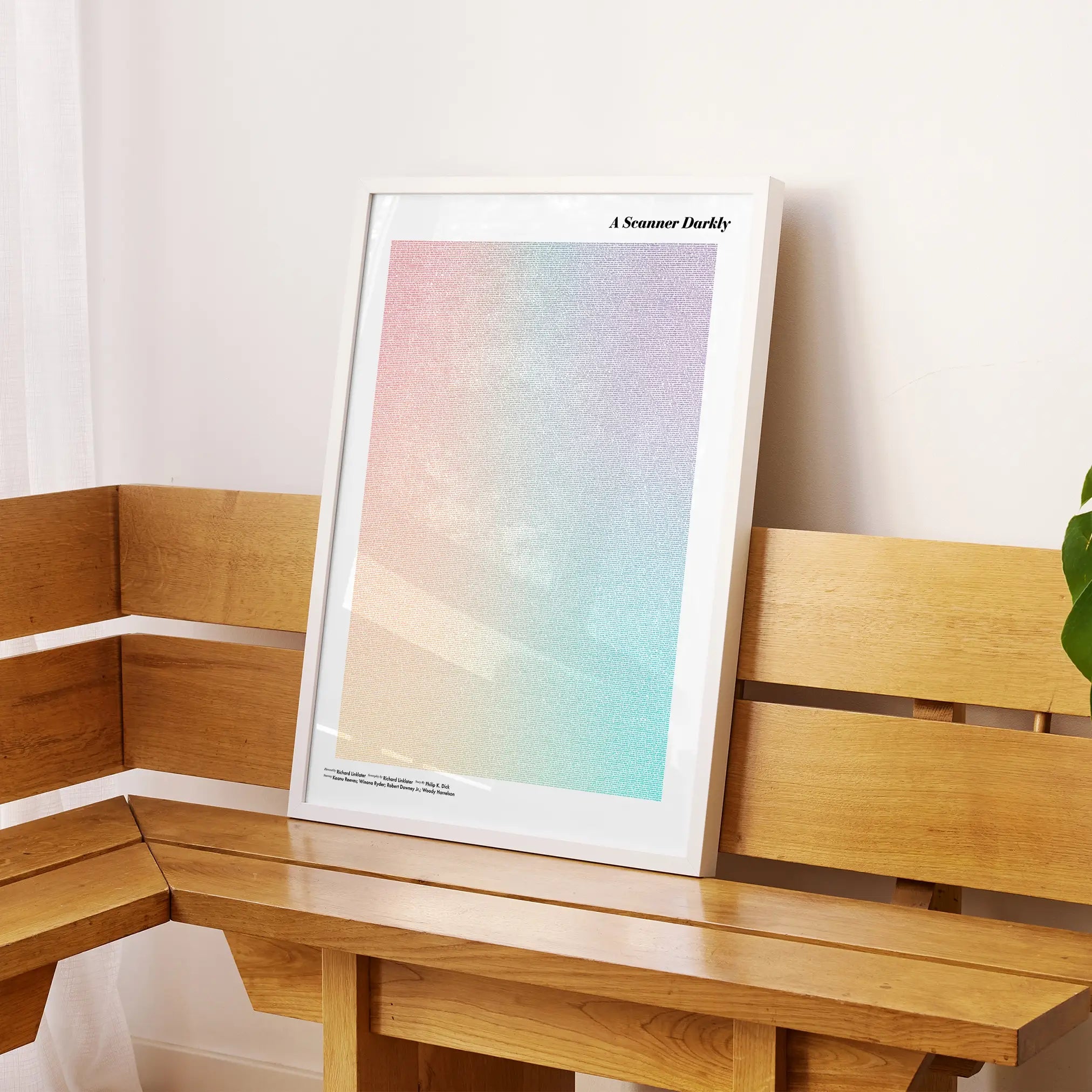 A framed A Scanner Darkly movie script poster displayed on a sideboard in a contemporary space.