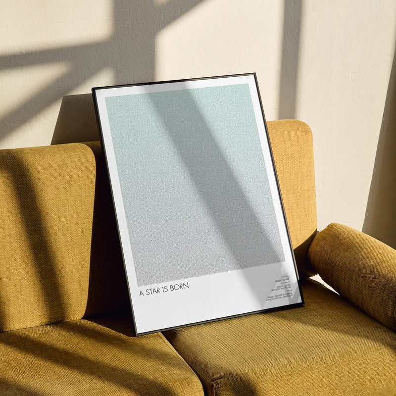 A framed A Star is Born movie script poster styled in a clean interior setting.