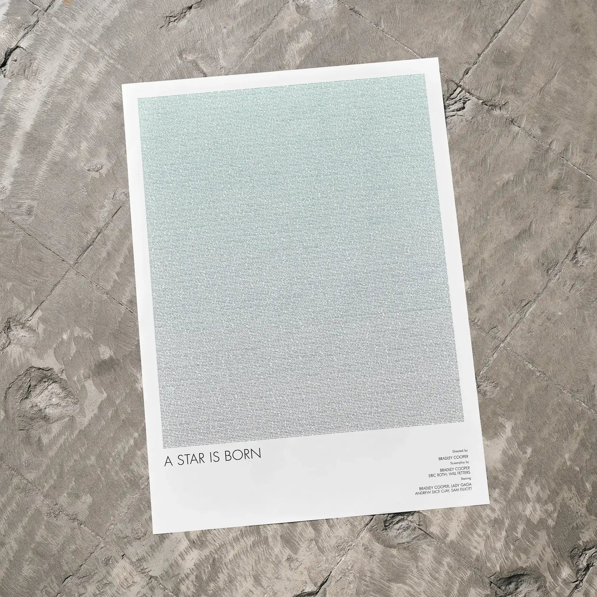 A A Star is Born movie script poster laid flat on a textured floor surface.