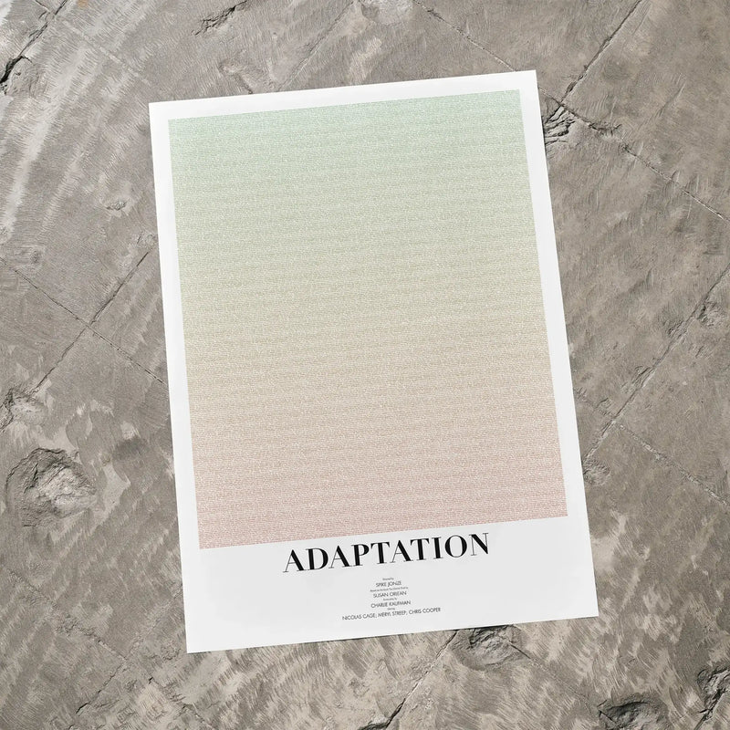 A Adaptation. movie script poster laid flat on a textured floor surface.
