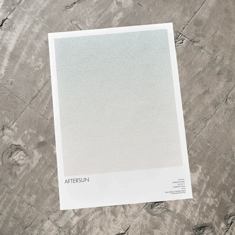 A Aftersun movie script poster laid flat on a textured floor surface.
