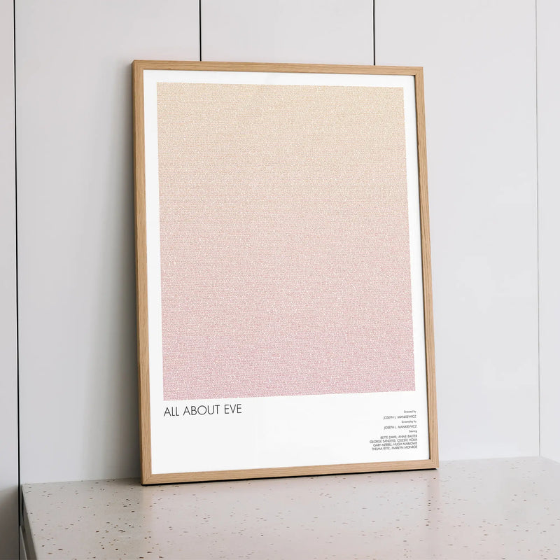 A framed All About Eve movie script poster styled within a calm interior space.