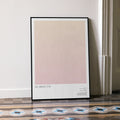 A framed All About Eve movie script poster leaning against a wall in a minimalist interior.