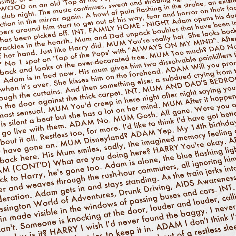 Close-up detail of the All of Us Strangers movie script poster showing dense typographic text.