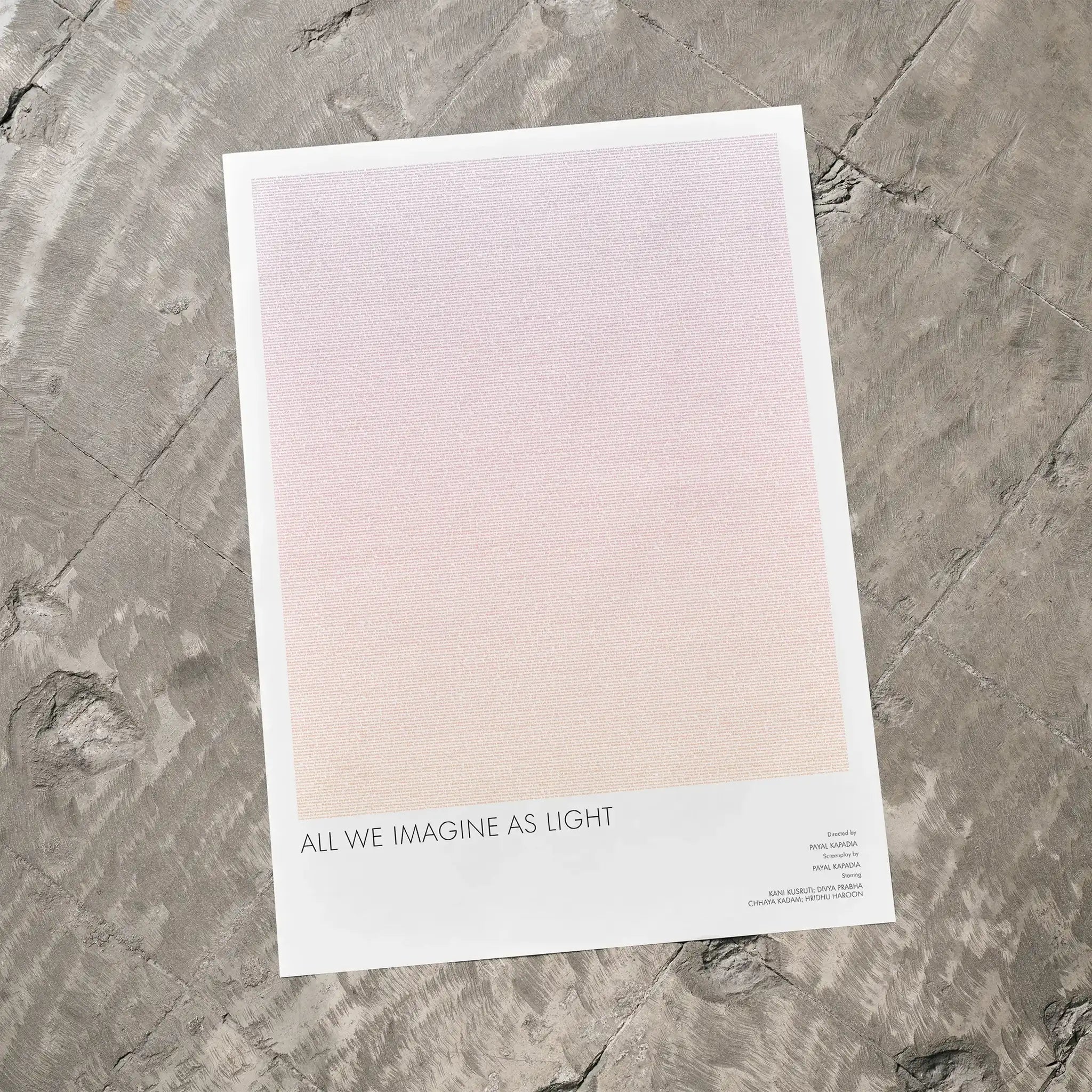 A All We Imagine as Light movie script poster laid flat on a textured floor surface.
