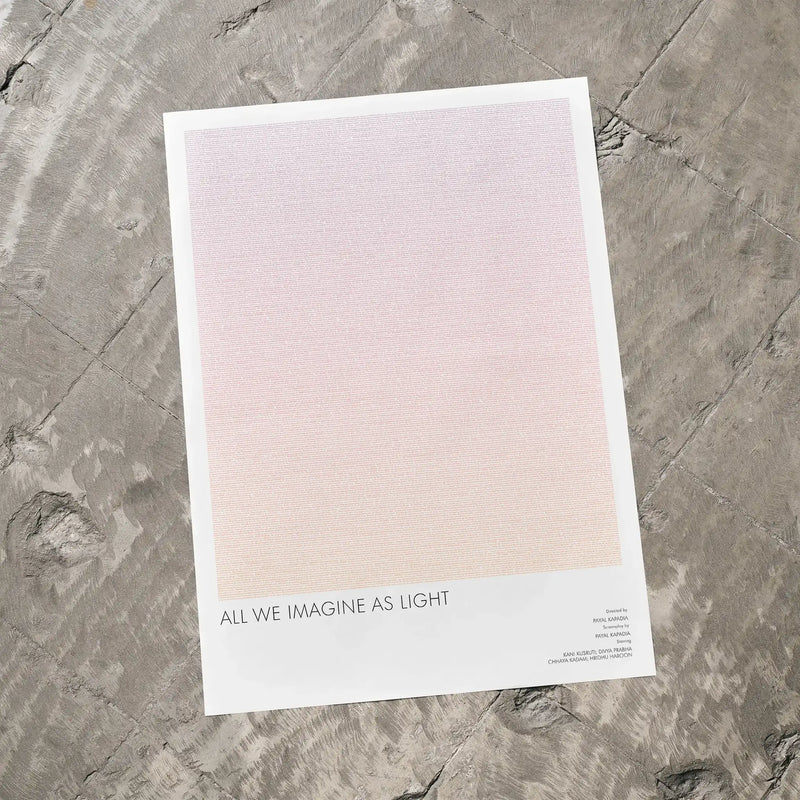 A All We Imagine as Light movie script poster laid flat on a textured floor surface.