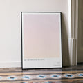 A framed All We Imagine as Light movie script poster leaning against a wall in a minimalist interior.