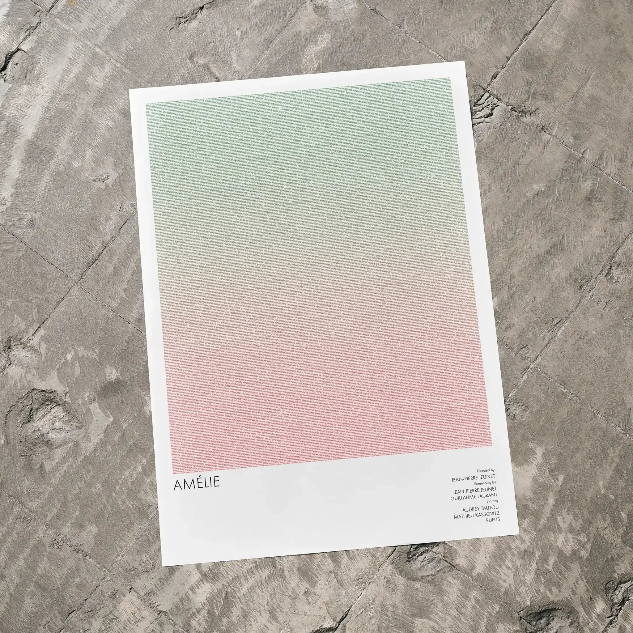 A Amélie movie script poster laid flat on a textured floor surface.