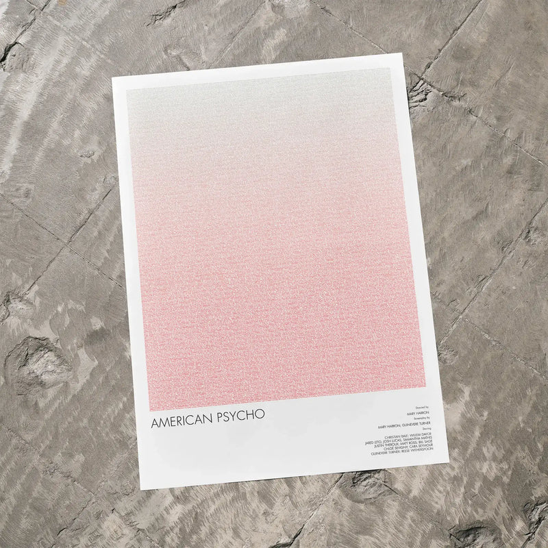 A American Psycho movie script poster laid flat on a textured floor surface.