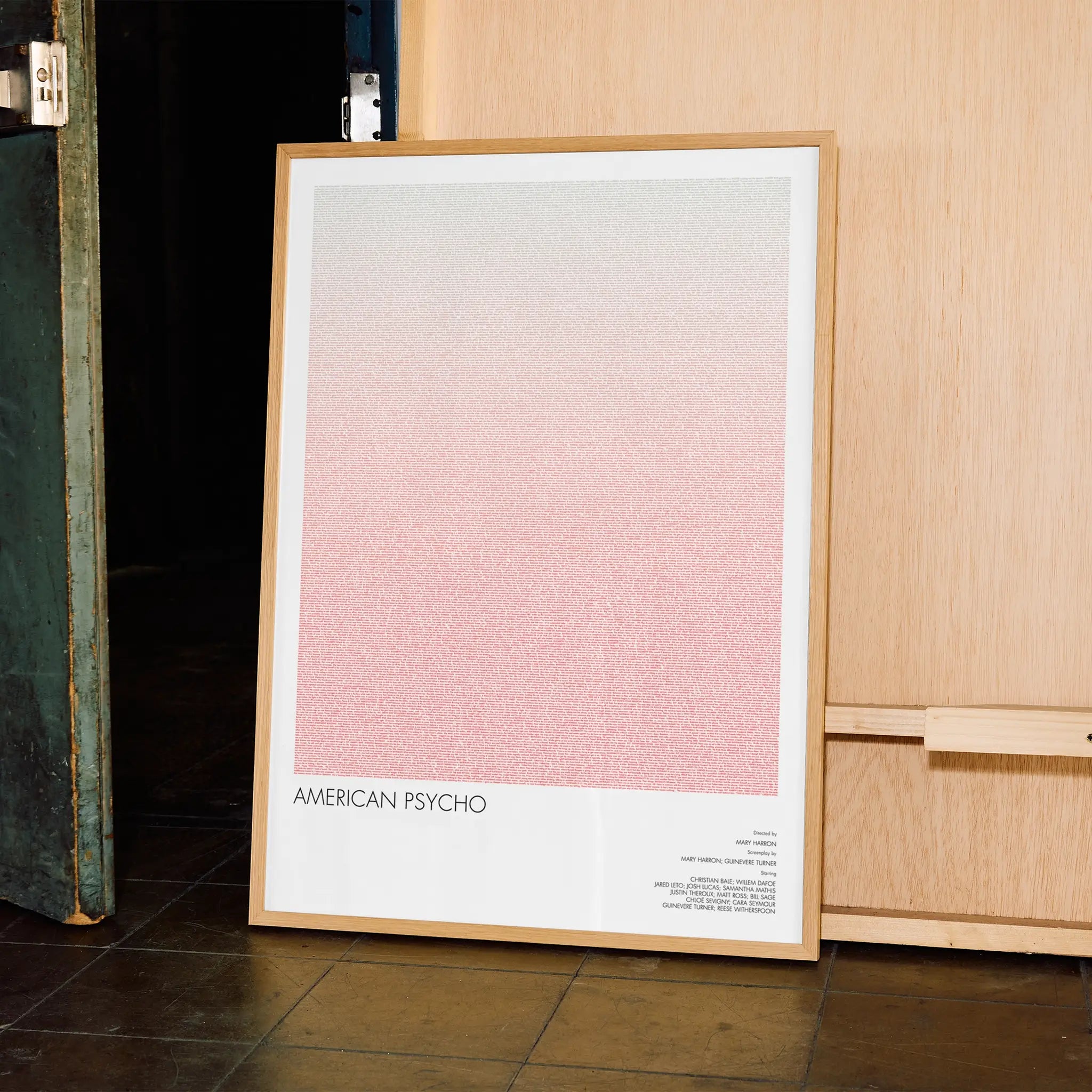 A framed American Psycho movie script poster displayed in a contemporary interior setting.