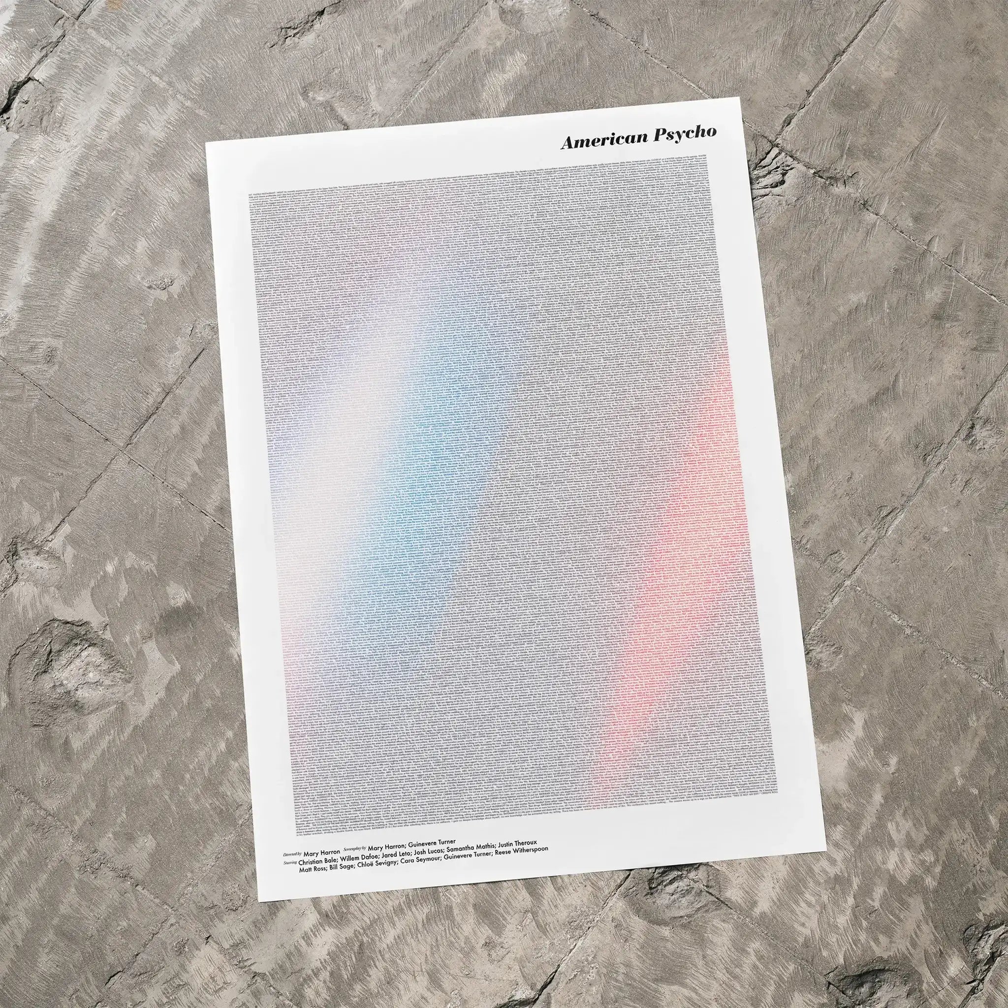 A American Psycho movie script poster laid flat on a textured floor surface.