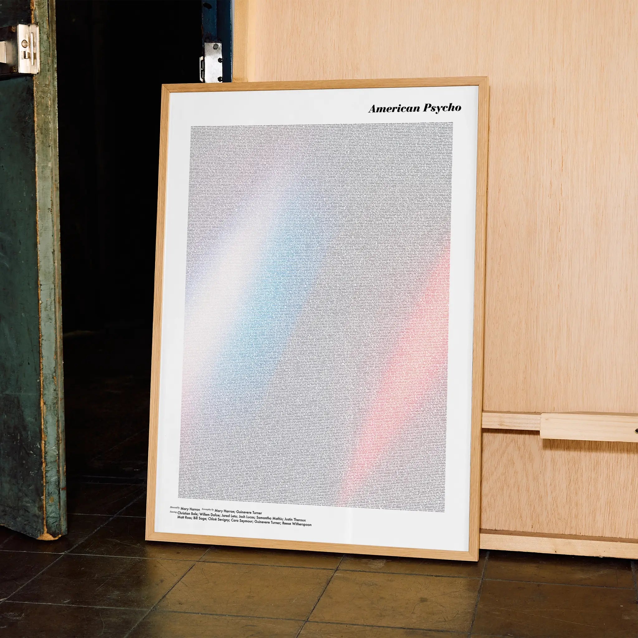 A framed American Psycho movie script poster displayed in a contemporary interior setting.