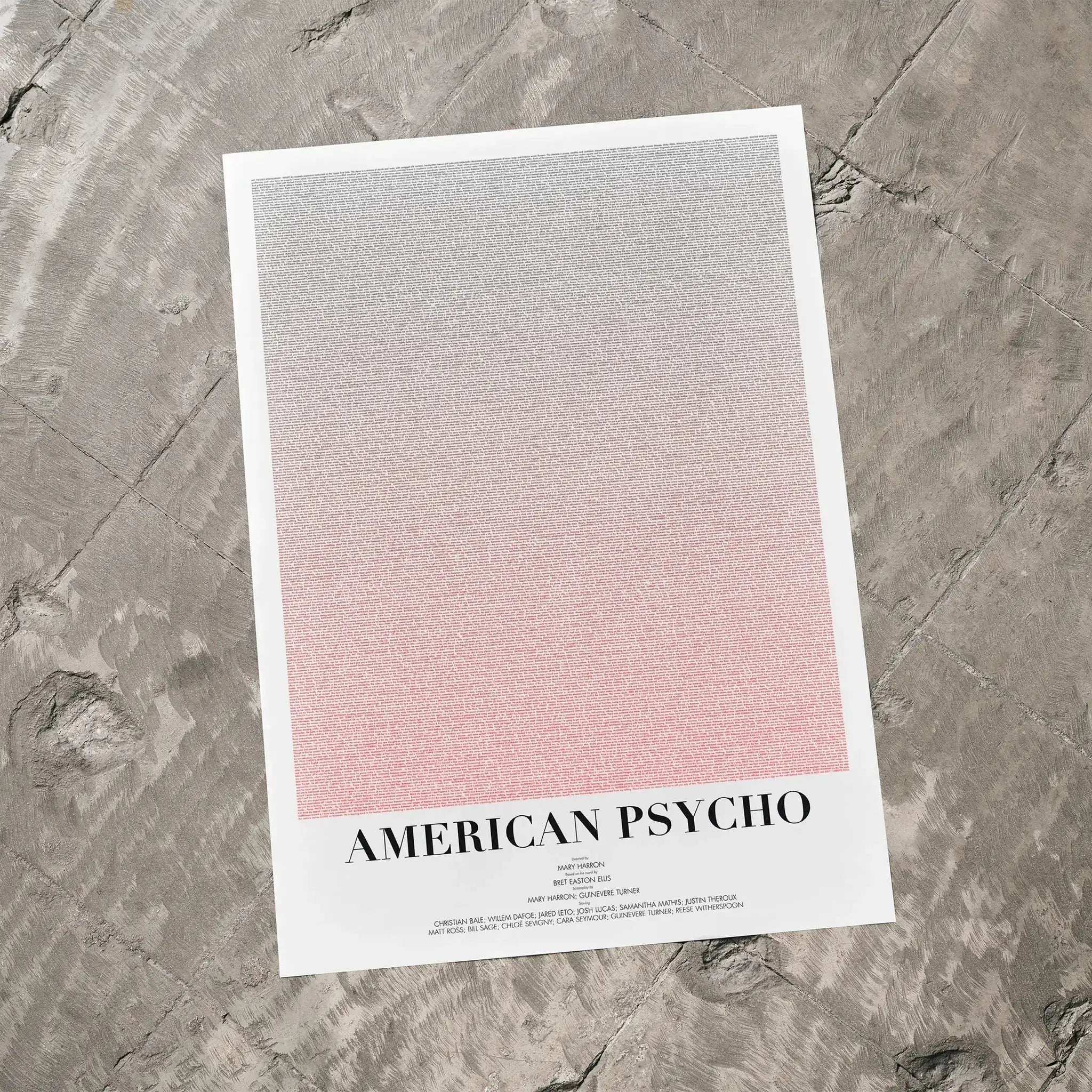 A American Psycho movie script poster laid flat on a textured floor surface.
