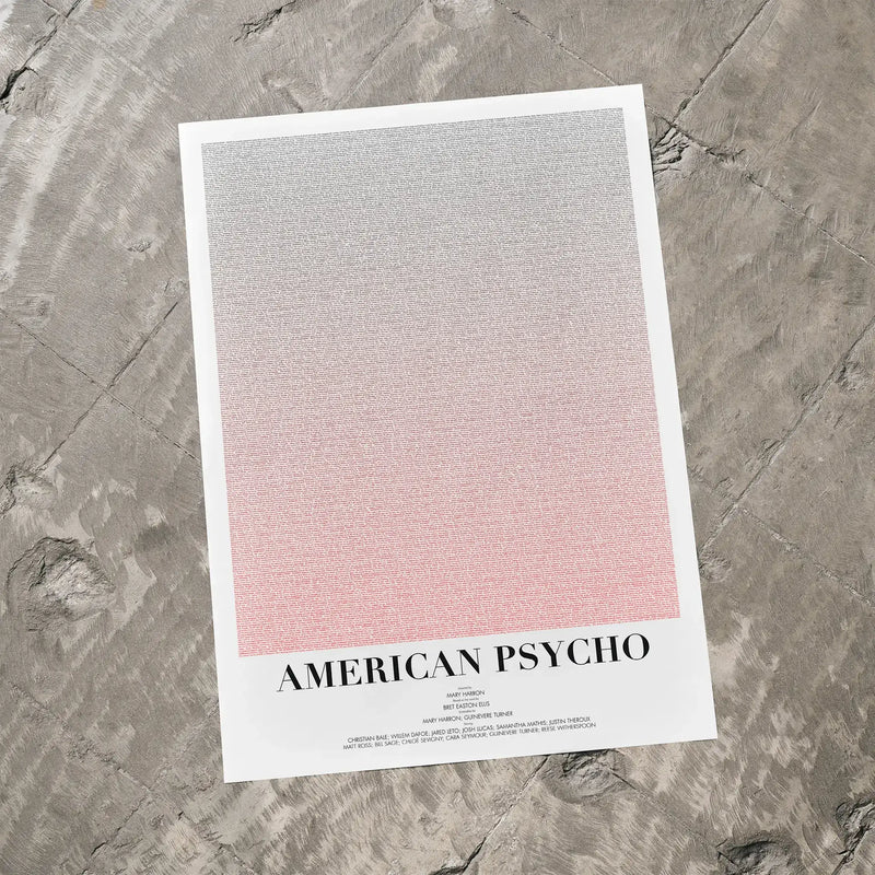 A American Psycho movie script poster laid flat on a textured floor surface.