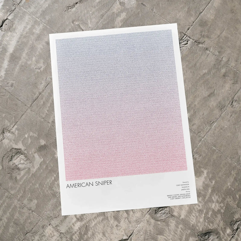 A American Sniper movie script poster laid flat on a textured floor surface.