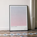 A framed American Sniper movie script poster leaning against a wall in a minimalist interior.