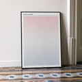 A framed American Sniper movie script poster leaning against a wall in a minimalist interior.